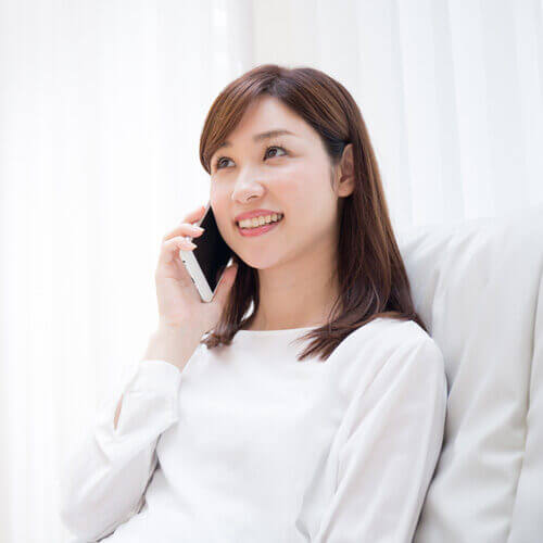 woman-smiling-talking-on-the-phone-circle