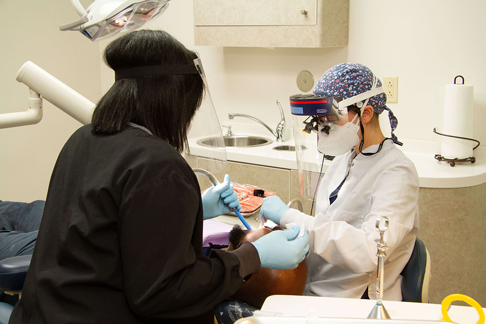 Dr. Goldenhersh and Briona treating a dental patient in University City